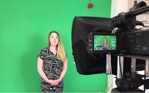 Trainee being filmed in front of a green screen