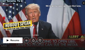 Screenshot of Nobody Speak: Trials of the Free Press documentary on Netflix. Trump gives speech against bright stars and stripes flag in the background.