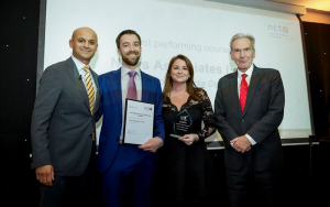 News Associates head of journalism Graham Moody and editorial development manager Lucy Dyer collecting the award for top gold-standard NCTJ journalism course in 2019 from Sky News presenter Dharmesh Seth and NCTJ chairman Kim Fletcher