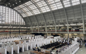 Photo of count at Olympia, London. Huge dome glass roof with counting booths across the large space.