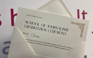 Photo of School of Journalism graduation ceremony invitation, invite poking out of envelope