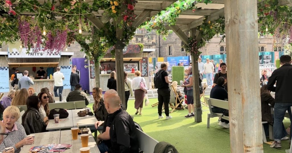 Edinburgh Fringe attendees at food and drink stalls.